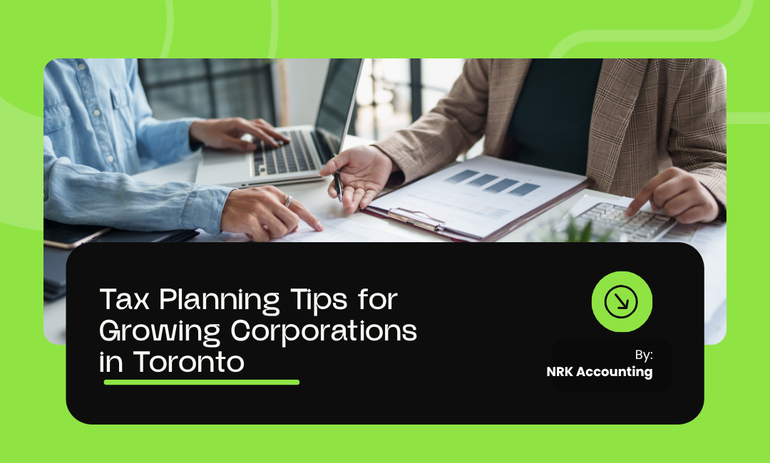 Two business professionals reviewing financial charts and tax planning documents with laptops and notepads on a desk, representing corporate tax planning in Toronto.